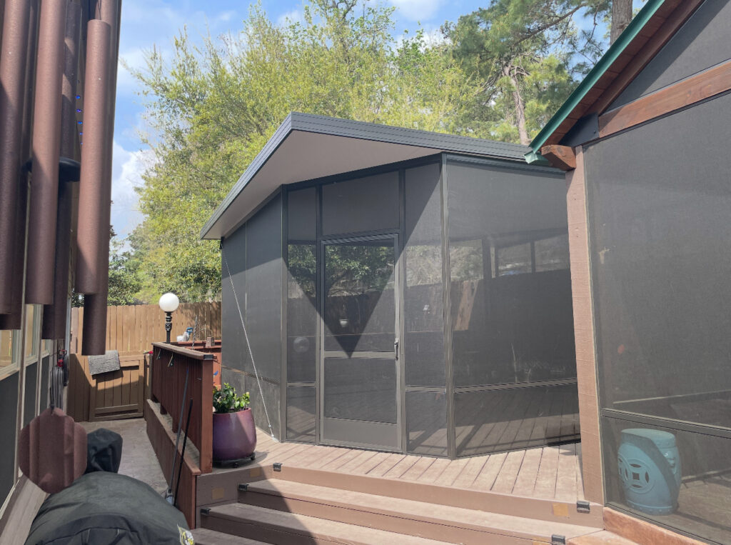 Freestanding screen enclosure with dark framing, custom-designed by Metal Masons for a decked patio retreat in Montgomery County.

